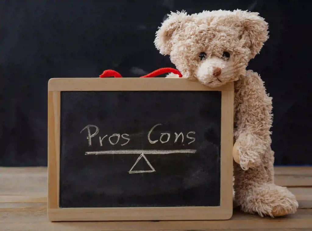 A-teddy-bear-holding-a-framed-chalkboard-displaying-pros-and-cons,-symbolizing-the-benefits-and-challenges-of-home-building-grants.